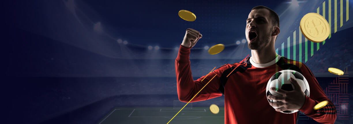 นักฟุตบอลถือลูกบอลสวมเสื้อแขนยาวสีแดง