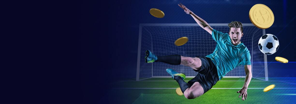 นักฟุตบอลสีขาวสวมเสื้อสีเขียวอมฟ้า กางเกงขาสั้นสีดำ ถุงเท้ายาวสีดำ และรองเท้าฟุตบอลสีเขียวอมฟ้าพยายามเตะลูกบอลขณะอยู่กลางอากาศ